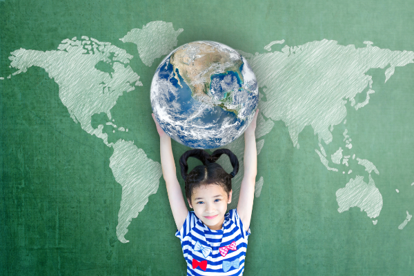 A child with long black hair holding the earth above their head, with a simple map of the world spread out behind them, on a sage green background.