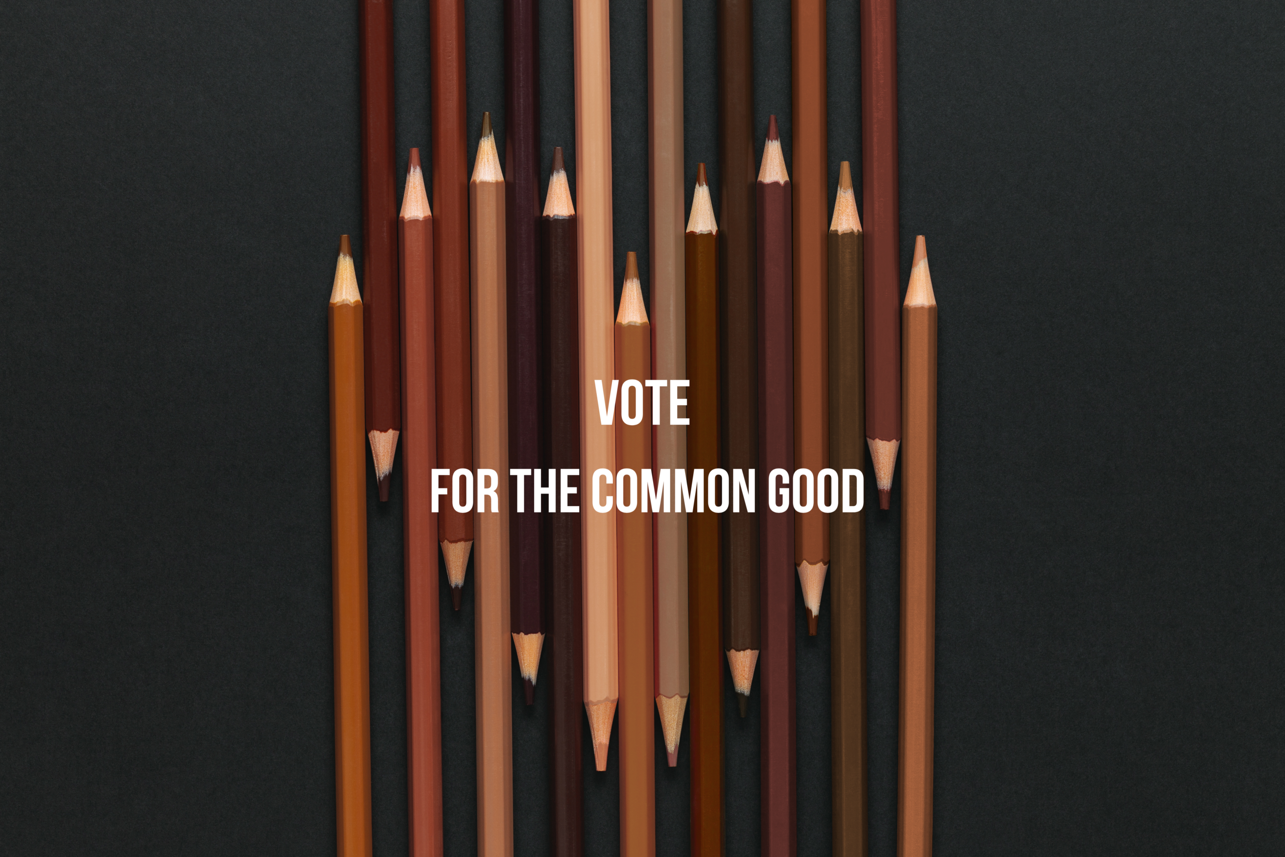 A heart shape made up of carefully arranged pencils in diverse shades of brown and black. Vote for the Common Good forms a header in contrasting white.